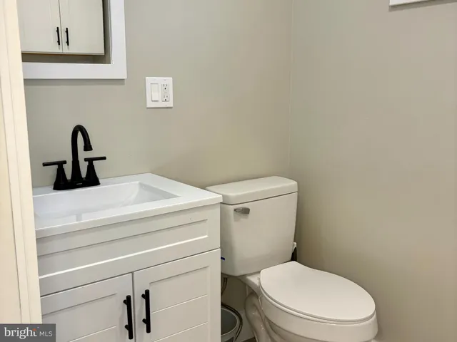 a white toilet sitting next to a bathroom sink