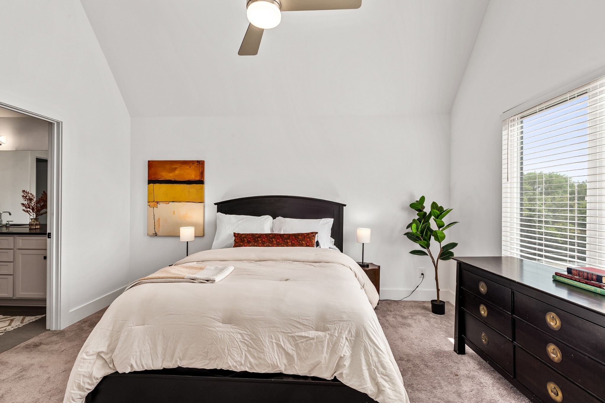 6002 Sterling Street Nashville, TN 37209 - Photo 16 of 37 a bedroom with a bed and a potted plant on the dresser