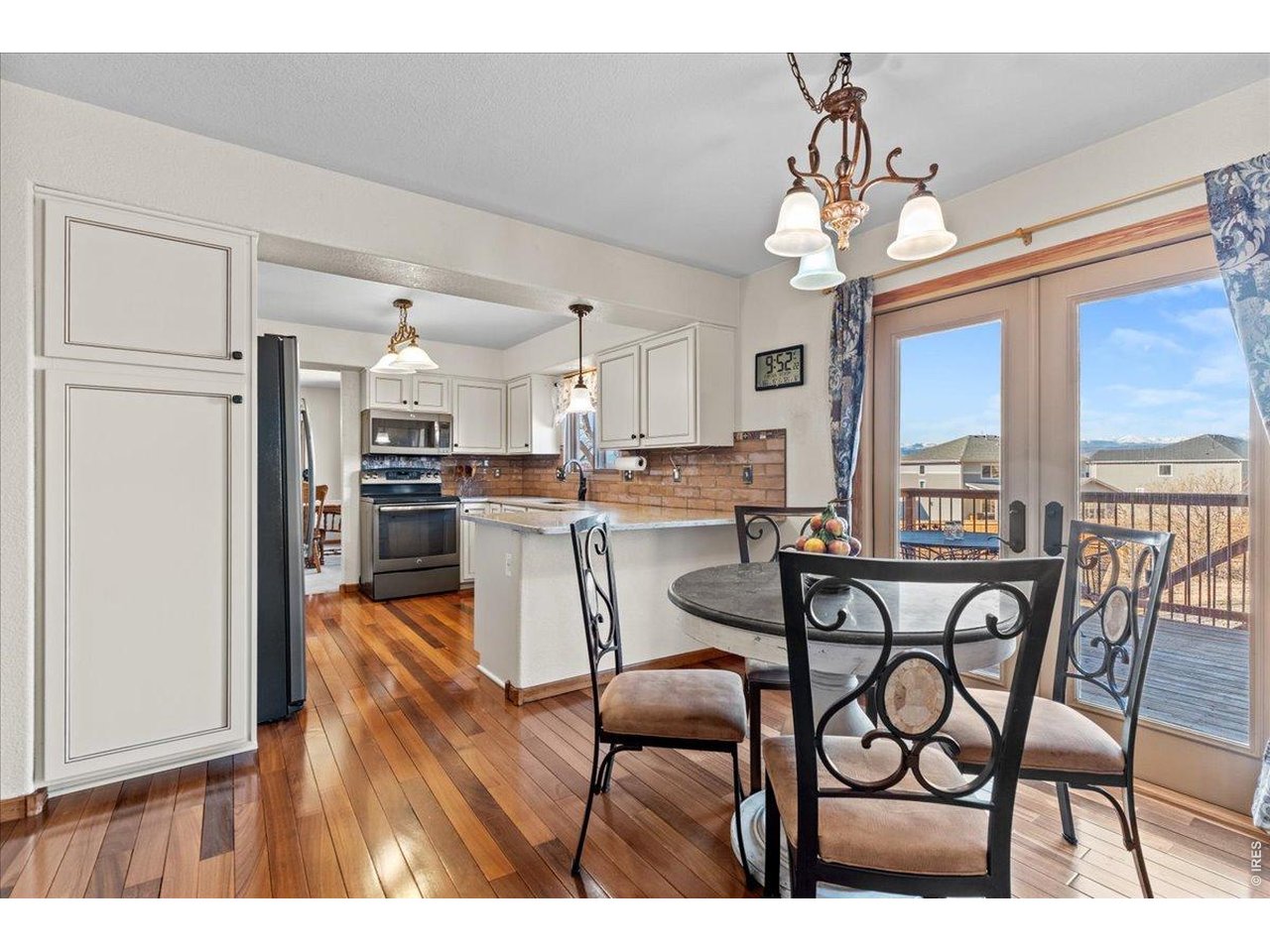 537 South 9th Street Berthoud, CO 80513 - Photo 12 of 47 a dining room with furniture a chandelier and wooden floor