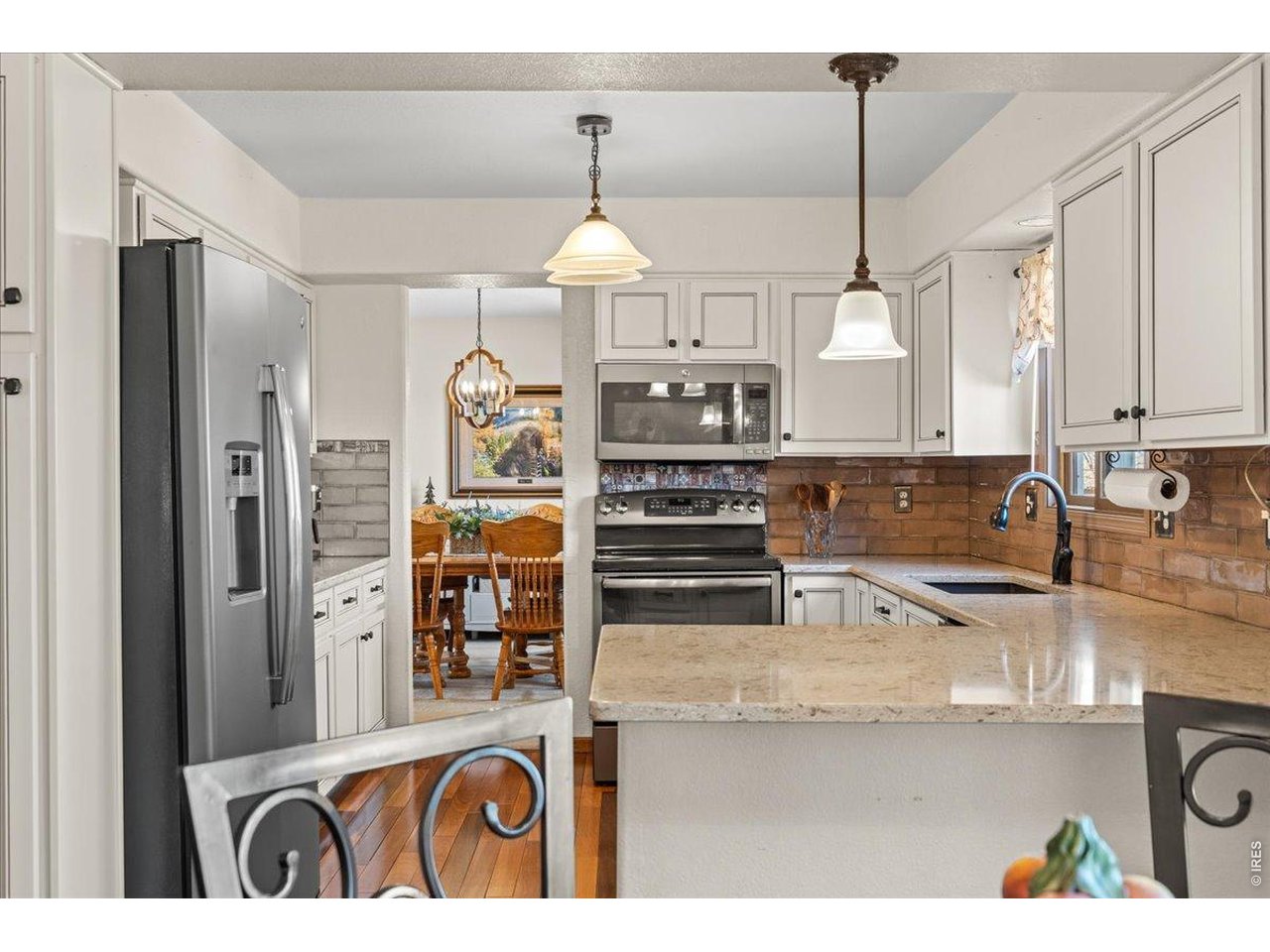 537 South 9th Street Berthoud, CO 80513 - Photo 13 of 47 a kitchen with stainless steel appliances granite countertop a sink a stove and refrigerator