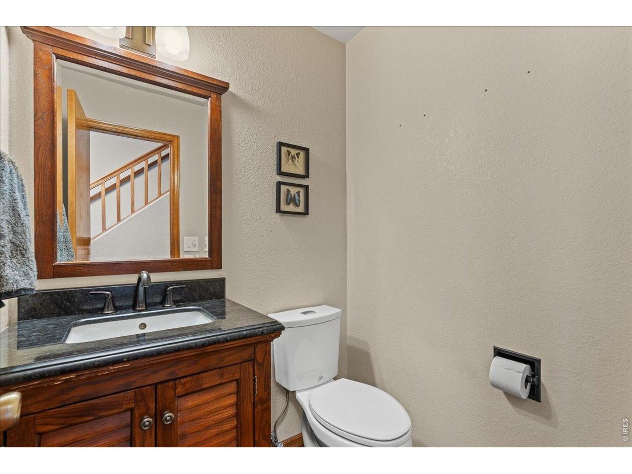 537 South 9th Street Berthoud, CO 80513 - Photo 21 of 47 a bathroom with a granite countertop toilet a sink and a mirror