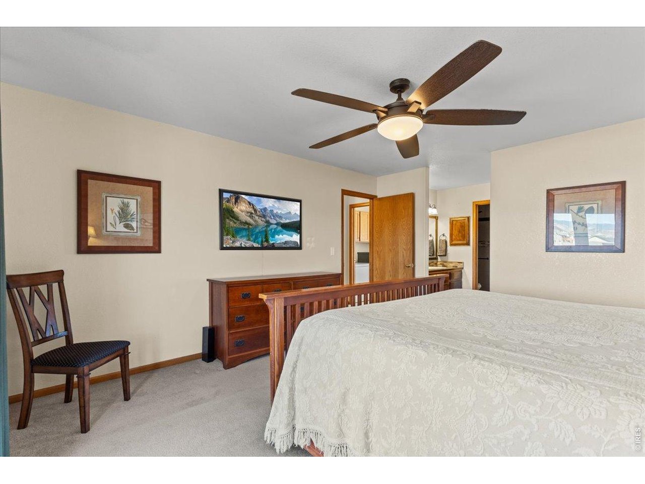 537 South 9th Street Berthoud, CO 80513 - Photo 23 of 47 a bedroom with a bed and a chandelier