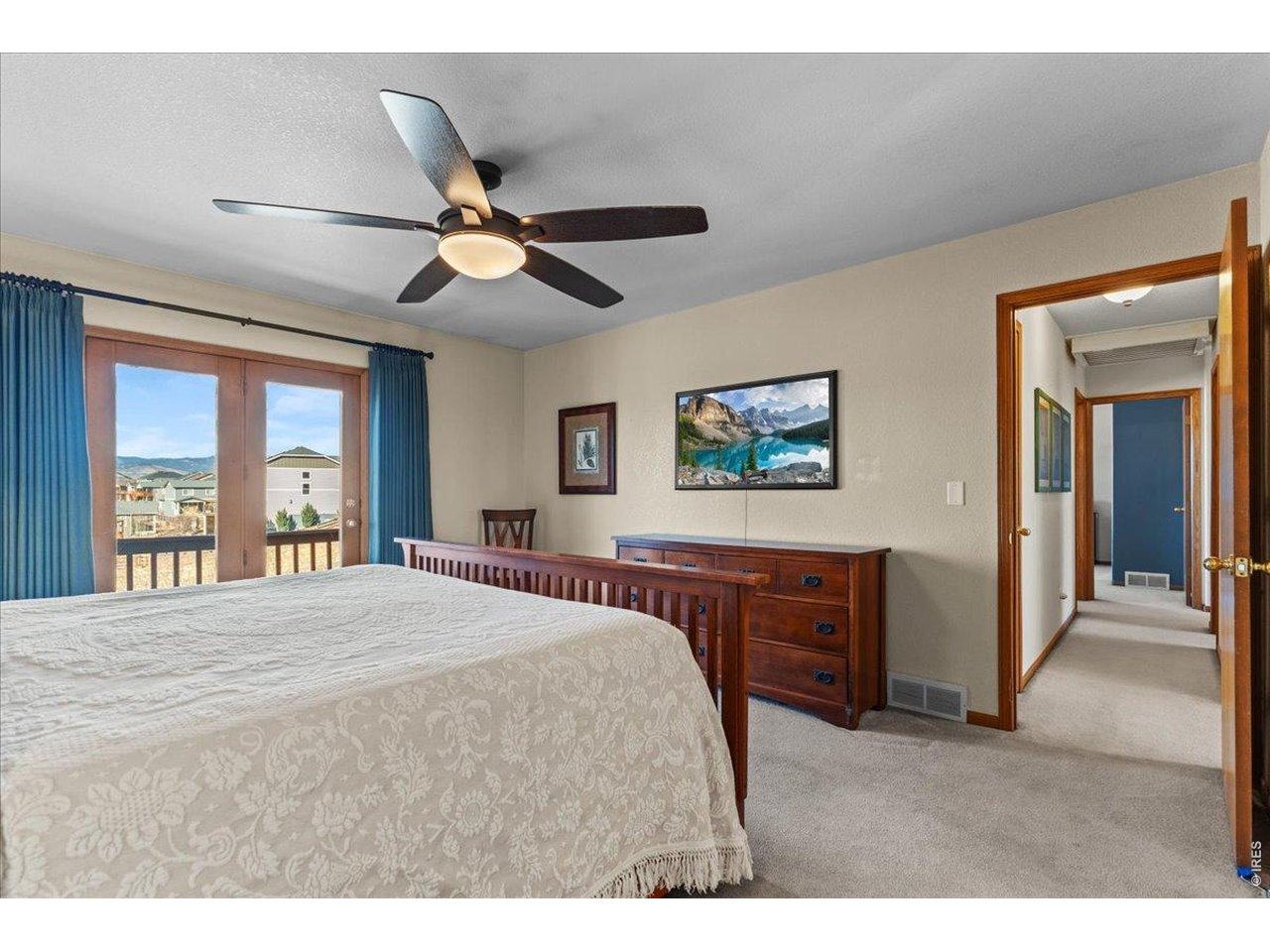 537 South 9th Street Berthoud, CO 80513 - Photo 24 of 47 a bedroom with a bed and a chandelier
