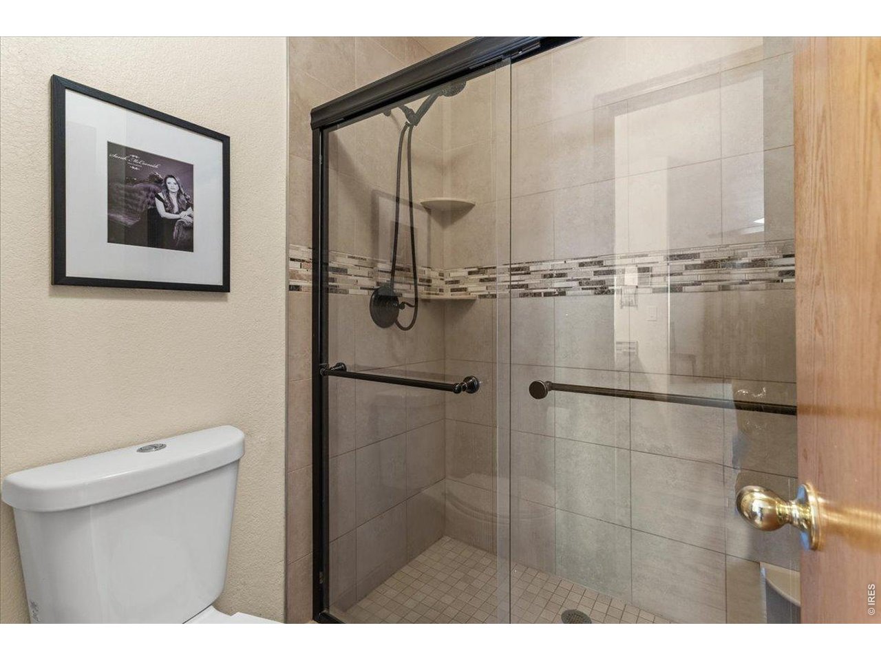 537 South 9th Street Berthoud, CO 80513 - Photo 27 of 47 a bathroom with a toilet a sink and a shower