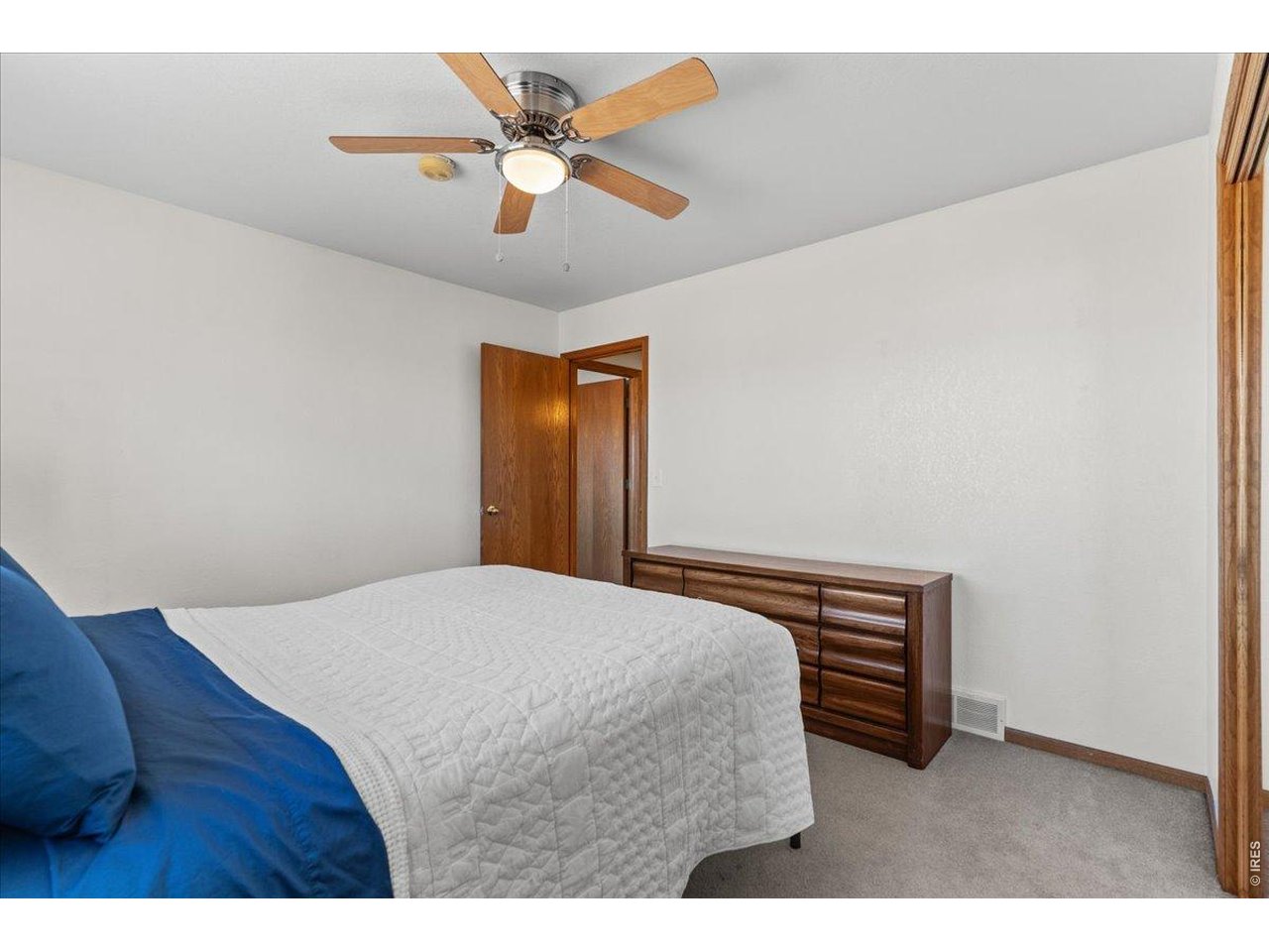 537 South 9th Street Berthoud, CO 80513 - Photo 29 of 47 a bedroom with a bed and a chandelier