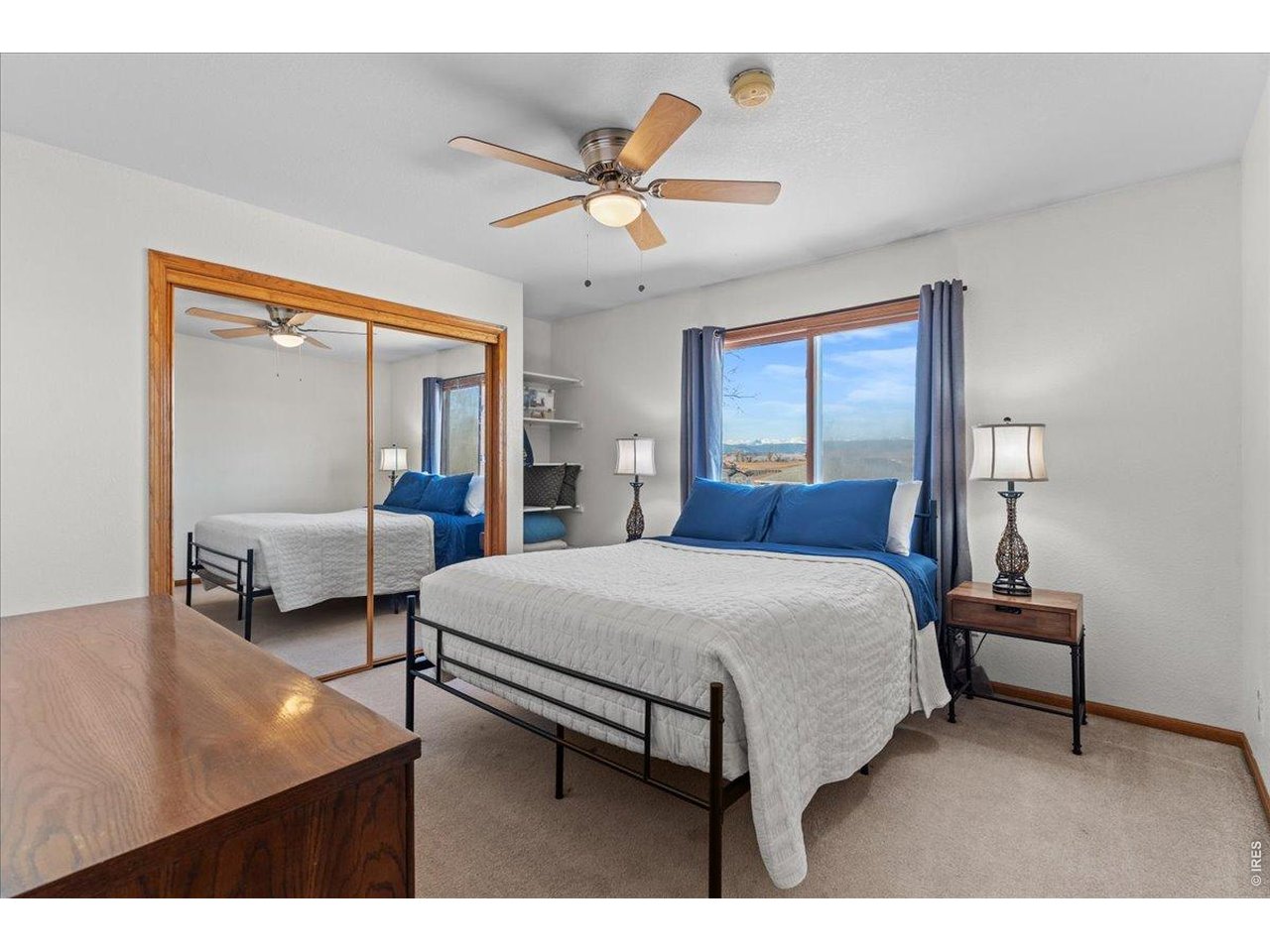 537 South 9th Street Berthoud, CO 80513 - Photo 30 of 47 a bedroom with a bed and a chandelier