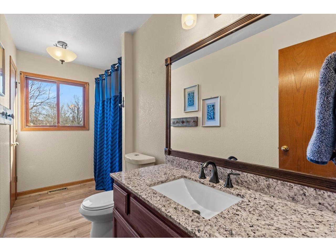 537 South 9th Street Berthoud, CO 80513 - Photo 31 of 47 a bathroom with a granite countertop sink and a mirror