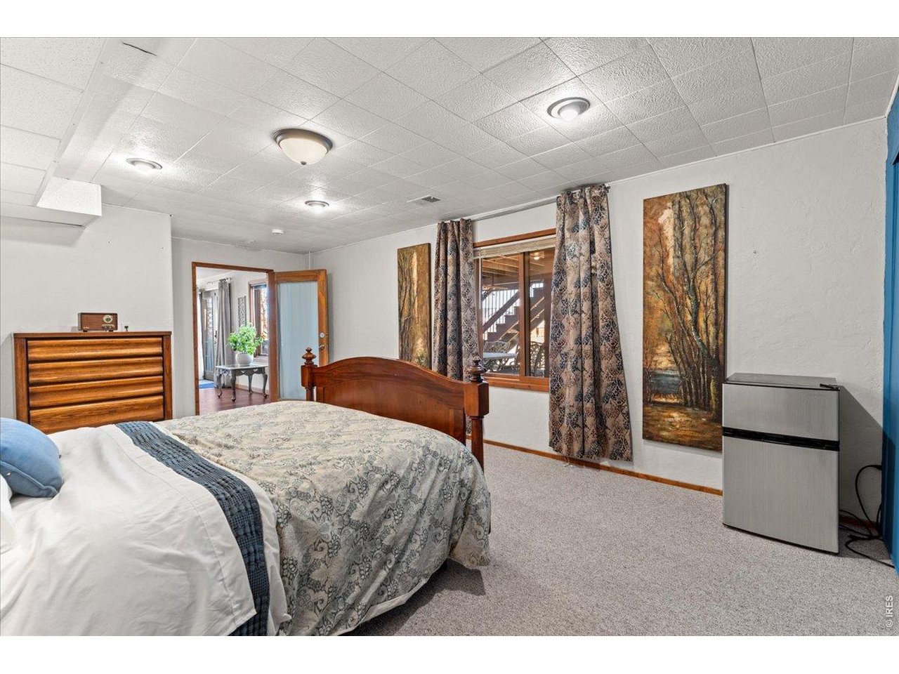 537 South 9th Street Berthoud, CO 80513 - Photo 39 of 47 a bedroom with a bed and a refrigerator