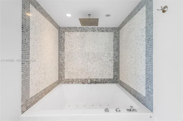 a bathroom with a bathtub and a shower