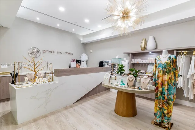 a living room with furniture a chandelier and a flat screen tv