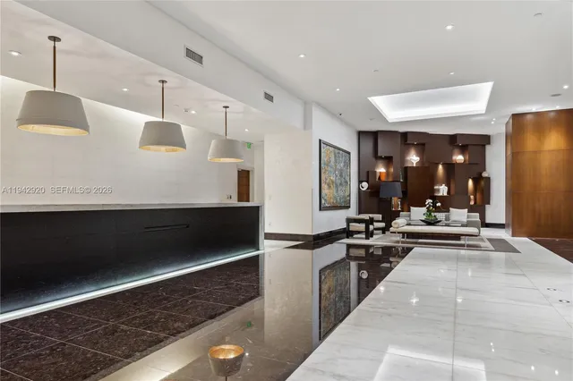 a kitchen with stainless steel appliances kitchen island granite countertop a refrigerator and a stove