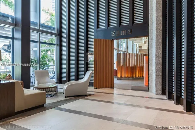 a view of a floor to ceiling window and an outdoor living room