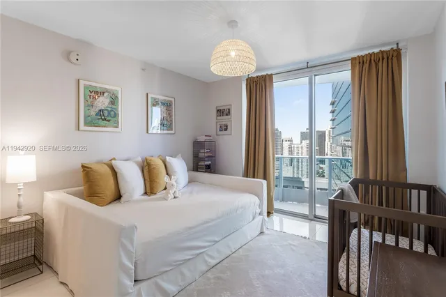 a bedroom with a bed and a large window