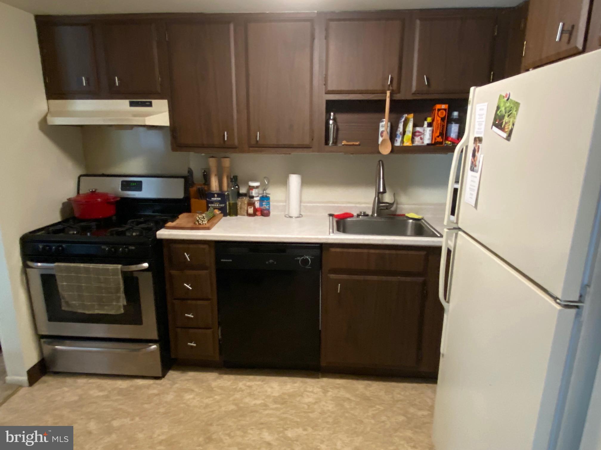 16 Old Forge Crossing, Unit 16 Devon, PA 19333 - Photo 8 of 12 a kitchen with a refrigerator and a stove