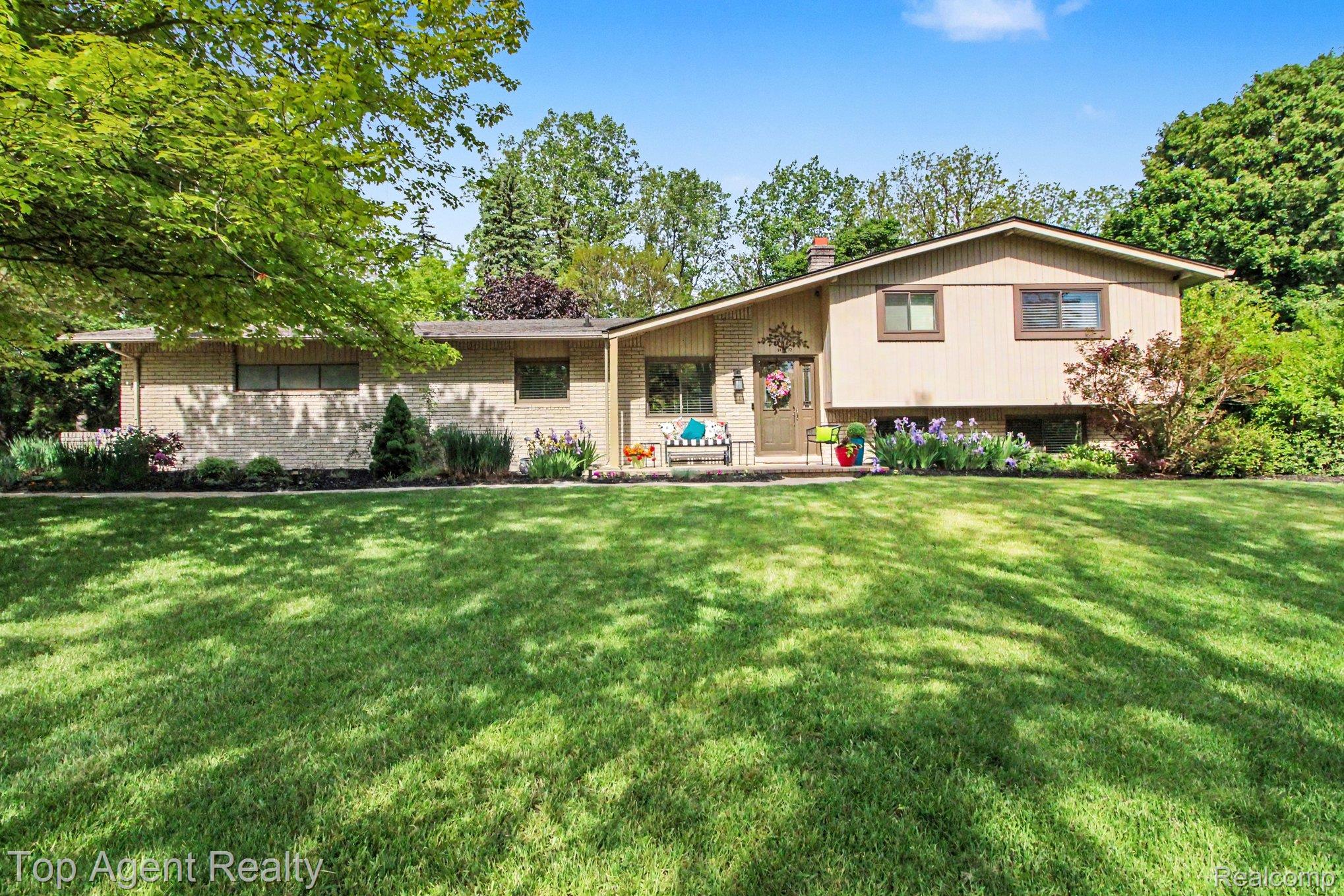 1372 New Life Lane Rochester, MI 48309 - Photo 1 of 30 Split-level residence featuring brick and siding exterior, front entry with covered porch, and extensive front lawn