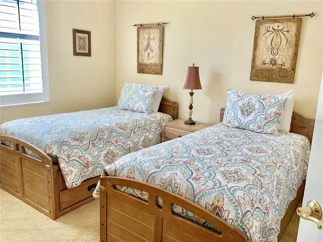 a bedroom with two beds and a window