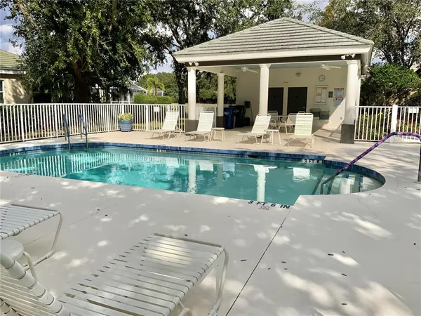 a view of a house with pool and a yard