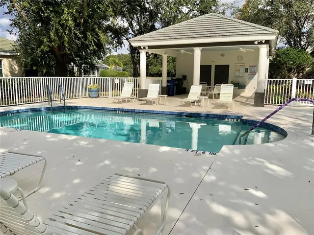 a view of a house with pool and a yard