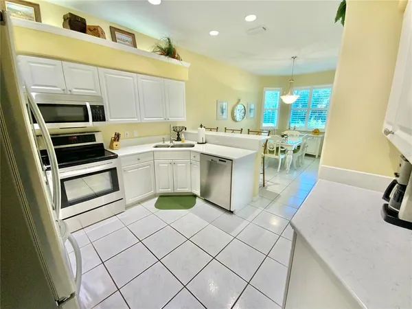 a kitchen with a sink a stove and chairs