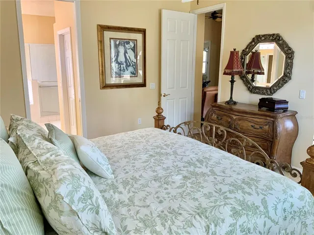 a bedroom with a bed and a mirror