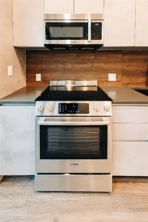 a stove top oven sitting inside of a kitchen