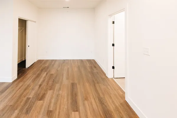 a view of a room with wooden floor