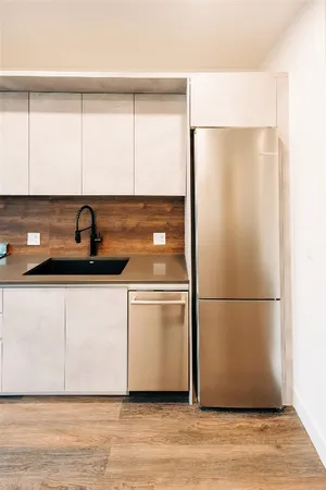 a kitchen with a refrigerator and a sink