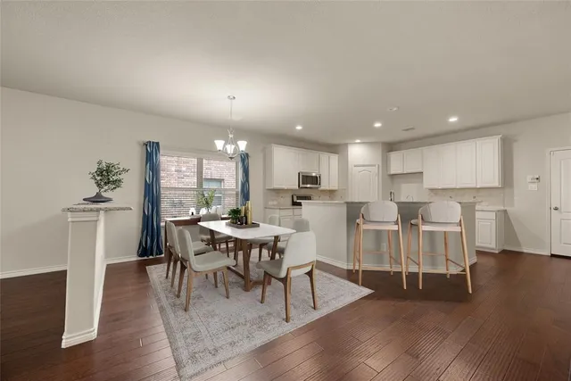 a view of a room with wooden floor and a ceiling fan