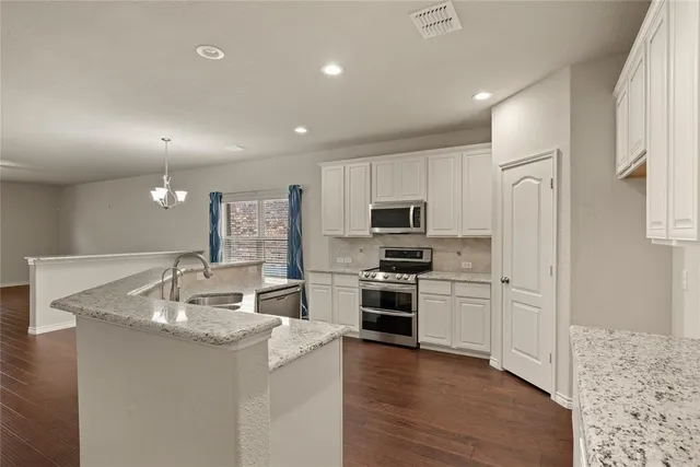 a kitchen with sink and cabinets