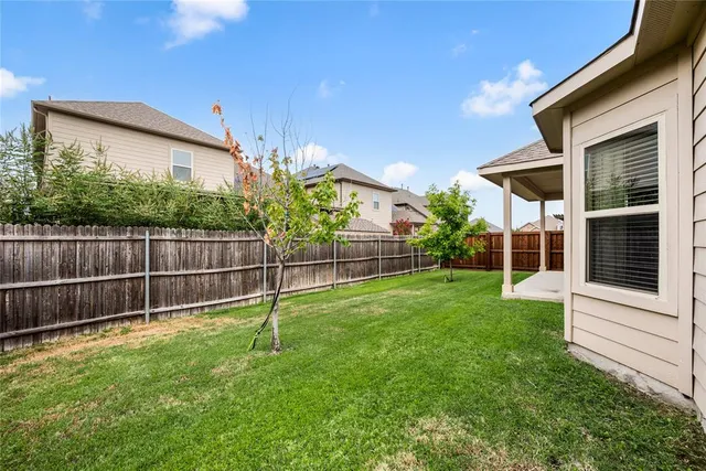 a front view of house with a garden