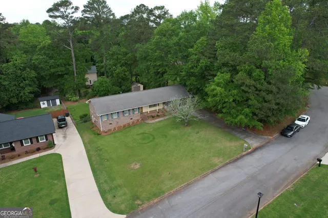 an aerial view of a house with a yard