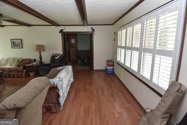 a view of a livingroom with furniture and a flat screen tv