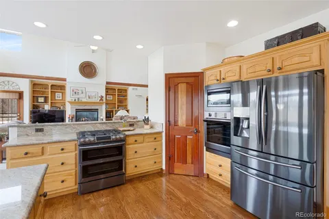 a kitchen with stainless steel appliances a stove a refrigerator and cabinets