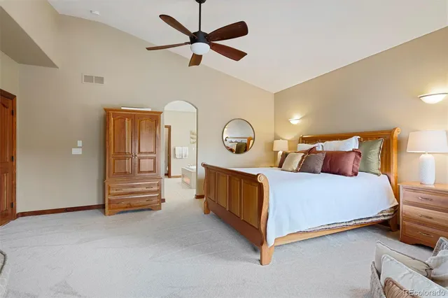 a bed room with a bed and a chandelier