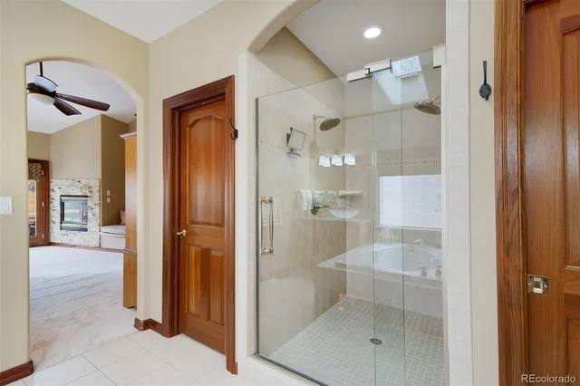 a bathroom with a shower and a glass door