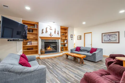 a living room with furniture fireplace and flat screen tv