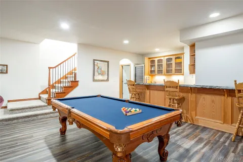 a room with pool table and windows