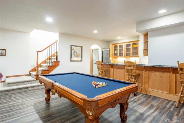 a room with pool table and windows