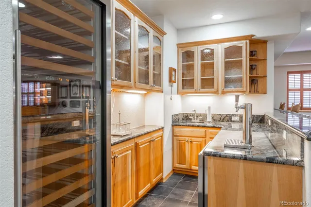 a kitchen with a refrigerator and a sink