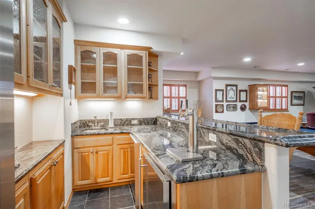 a kitchen with stainless steel appliances granite countertop a sink and a stove