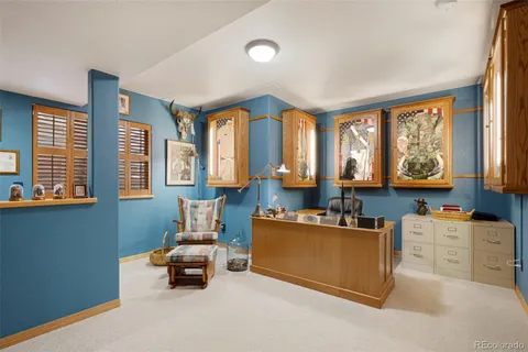 a living room with furniture and large windows