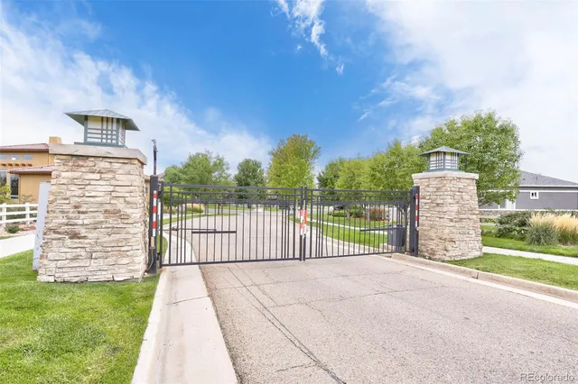 a view of a pathway with a wrought fence