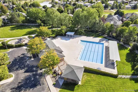a view of a house with backyard and a sitting area