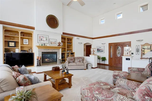 a living room with furniture wooden floor and a fireplace