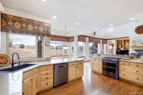 a kitchen with stainless steel appliances granite countertop a sink and cabinets