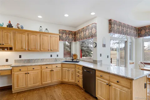 a large kitchen with a sink and cabinets