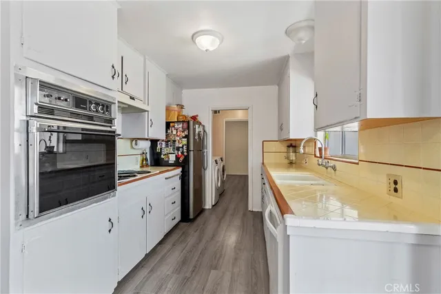 a kitchen with cabinets and stainless steel appliances