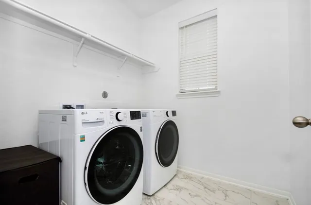 a view of a kitchen with white cabinets