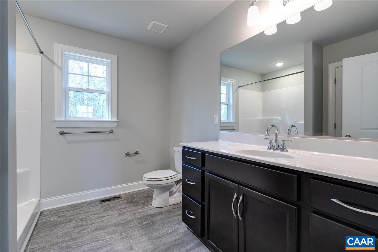 2581 Bumpass Road Beaverdam, VA 23015 - Photo 15 of 16 a bathroom with a toilet a sink a mirror a and a window