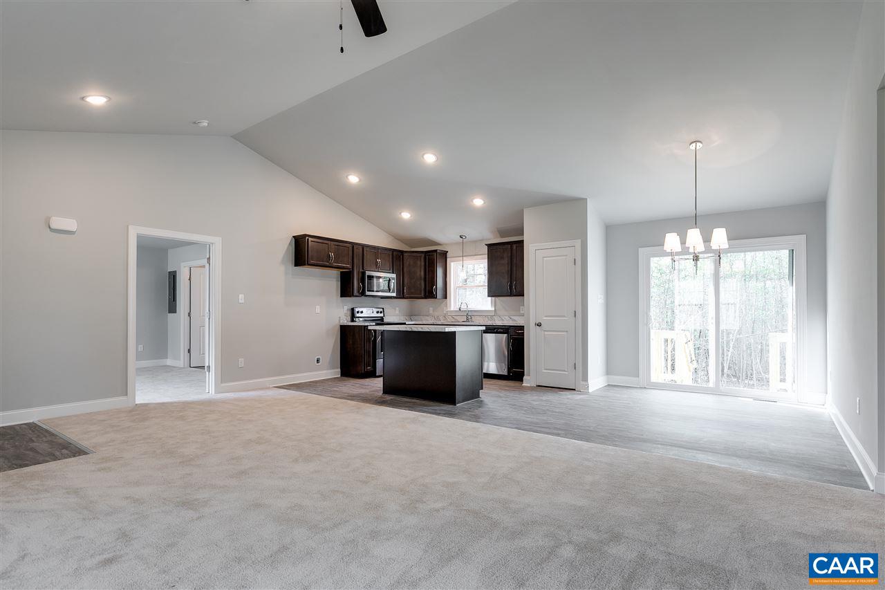 2581 Bumpass Road Beaverdam, VA 23015 - Photo 3 of 16 a large white kitchen with kitchen island a island a sink stainless steel appliances and cabinets